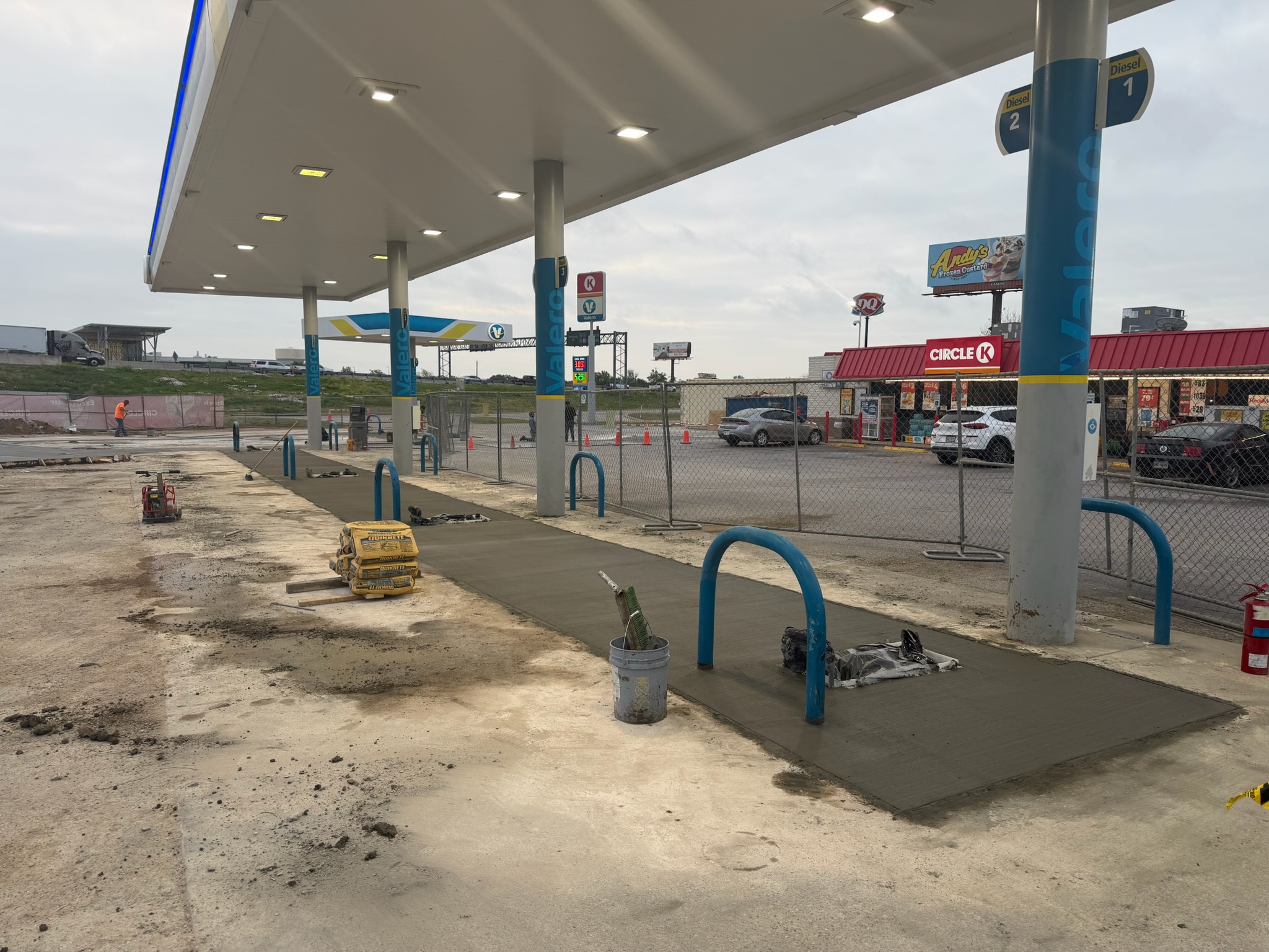 Commercial sidewalk pour at a Valero fuel station with equipment staged on site